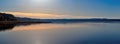 Panorama of a magnificent sunset on the lake, with a Golden-blue color Royalty Free Stock Photo