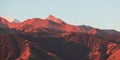 Panorama of the majestic beautiful and picturesque mountains, illuminated by the morning sun in orange colors during sunrise. Royalty Free Stock Photo