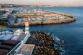 Panorama of marina and coastline of Cascais, Portugal with Santa Marta lighthouse at sunset Royalty Free Stock Photo