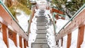 Panorama Metal grate tread stairs on snowy hill going down to a road viewed in winter Royalty Free Stock Photo