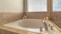 Panorama Modern bathroom interior with circular bathtub in front of window with blinds