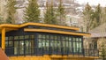 Panorama Modern home exterior with yellow wall balcony flat roof and large windows