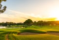 Panorama of the most beautiful sunset or sunrise. Sand bunker on a golf course without people with a row of trees in the Royalty Free Stock Photo