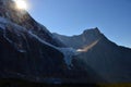 Panorama of Mount Edith Cavell. High mountains with glacier, sun rays illuminate the forest.