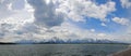 Panorama of Mount Moran and Grand Teton Peaks under cumulus clouds at Jackson Lake in Grand Teton National Park in Wyoming USA