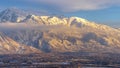 Panorama Mount Timpanogos over homes with snow at winter and illuminated by golden sunset
