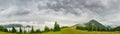 Panorama of the mountain glade in Carpathians in rainy weather Royalty Free Stock Photo