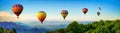 Panorama of mountain with hot air balloons on morning at Thailand. Royalty Free Stock Photo