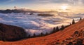 Panorama of the mountain landscape above clouds at sunset with sun Royalty Free Stock Photo