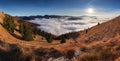 Panorama of the mountain landscape above clouds at sunset with sun Royalty Free Stock Photo