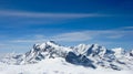 Panorama mountain landscape in the Swiss Alps near Zermatt on a beautiful day in late winter under a blue sky Royalty Free Stock Photo