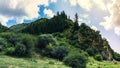 Mountain valley in the summer. A fabulous view of the mountain peaks, amazing nature. Mountain forest road. Green mountains with t