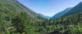 Panorama of mountains covered with green and blue sky with clouds. View of the valley Royalty Free Stock Photo