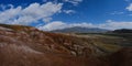 Panorama of the mountains. Magnificent views of the Altai mountains of red against the blue sky. Siberia, Altai