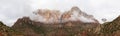 Panorama of the mountains of Zion National Park in Utah with a heavy overcast and clouds dramatically passing in from of the peaks