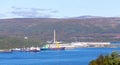 Panorama of the Mumansk sea port on a sunny summer gay. Cranes, cargo ships, ÃÂ½eavy loading and unloading operations