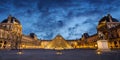 Panorama of the museum and pyramid of Le Louvre illuminated at night in Paris France Royalty Free Stock Photo