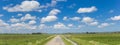 Panorama of a narrow coutry road in the dutch landscape