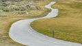 Panorama Narrow road paved with concrete and winding through the slope of a hill