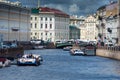 Panorama of Neva with the pleasure boats in the river. Sunday afternoon. Cloudy sky