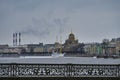 Panorama of the Neva River embankment with the Assumption Church and a sailing ship in winter