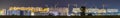 Panorama night view of many building cranes at construction site Royalty Free Stock Photo