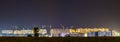 Panorama night view of many building cranes at construction site Royalty Free Stock Photo
