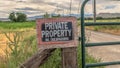 Panorama No Trespassing sign on the wire fence and green metal gate of private property Royalty Free Stock Photo