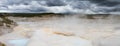 Panorama of Norris Geyer Basin under dark clouds