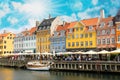 Panorama of north side of Nyhavn with colorful facades of old houses and old ships in the Old Town of Copenhagen