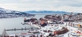 Panorama Norway Narvik, view of the city and the bay, with one ship being loaded up at the iron ore plant, a winter day Royalty Free Stock Photo