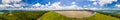 Panorama of Numerous wind turbines in the vast forest with mountains and sky as background Royalty Free Stock Photo