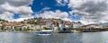 Panorama of Ohrid city, lake and boat taking tourist on panoramic tour ride