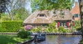 Panorama of an old house at the canal in Giethoorn