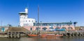 Panorama of an old wooden ship in front of the terminal in Harlingen Royalty Free Stock Photo