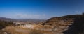 Panorama of an open mine or quarry on a sunny day at Verd, Slovenia. Visible terraces and vast surface of sand and stones, with a Royalty Free Stock Photo