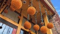 Panorama Orange light balls hanging at the entrance of a building with red brick wall