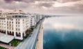 panorama over the promenade of Thessaloniki city with facades of buildings and a walking pedestrian path along the sea.