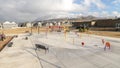 Panorama Park and childrens playground against homes and snow capped mountain in winter