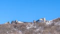 Panorama Park City Utah mountain scenery in winter with homes against blue sky background