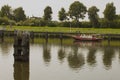 Particular boat on Holland canal in front of dutch style