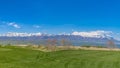 Panorama Pathway amid a rich green field leading to houses in the distance Royalty Free Stock Photo