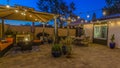 Panorama Patio of home with seating area under a gazebo and dining area under an umbrella Royalty Free Stock Photo