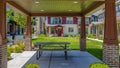 Panorama Patio on a lawn surrounded by houses under blue sky