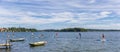 Panorama of people doing standup paddleboarding in the lake of Plon