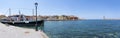 Panorama photo from Akti Tompazi street with an old ship on the quay and the beautiful Venetian buildings and the old lighthouse i