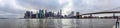 Panorama photo of the Brooklyn Bridge and Manhattan with the tops of the skyscrapers reaching the clouds in New York, United State Royalty Free Stock Photo