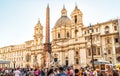 Panorama of Piazza Navona in Rome, Italy. People walk past Sant`Agnese church and Four Rivers fountain with Egyptian obelisk Royalty Free Stock Photo