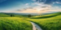 Panorama of picturesque mountain scenery in the Alps with fresh blooming green fields cutting the road on a sunny spring day,