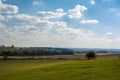 Panorama of a picturesque view of a plowed field and forested areas in the background in the fall in the morning